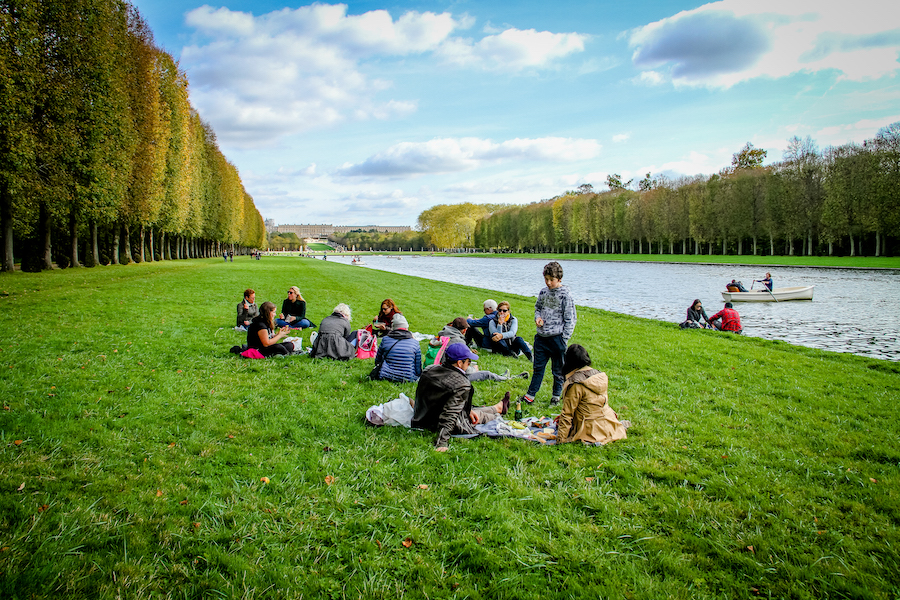 Parisians having a picnic on the side of a river 