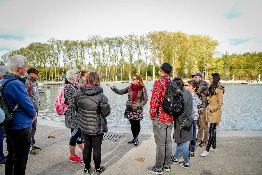 group of individuals on a group tour around body of water