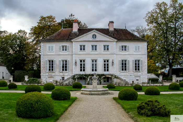 Three story white building located in Burgundy, France. Vineyard