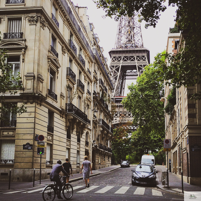 View of Eiffel Tower where bikers make their way. 