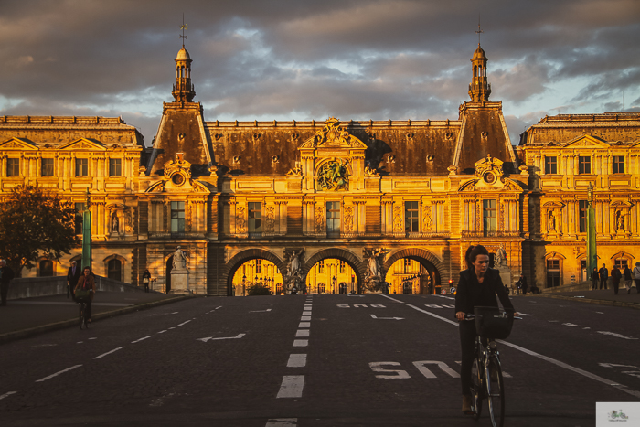 sunset in Paris, women biking towards camera