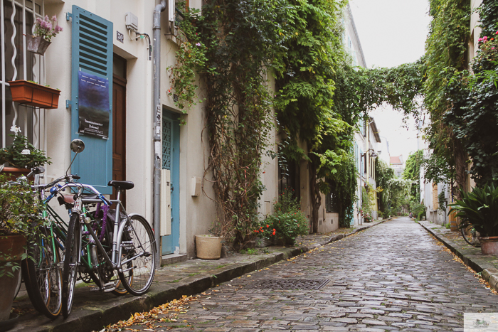 Fresh rain on Brick stone street in Paris. Bikes parked on left side of image