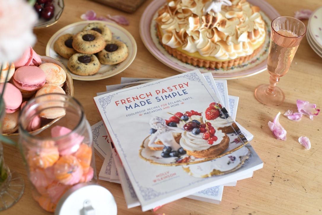 French Pastry Made Simple book surrounded by actual French pastries