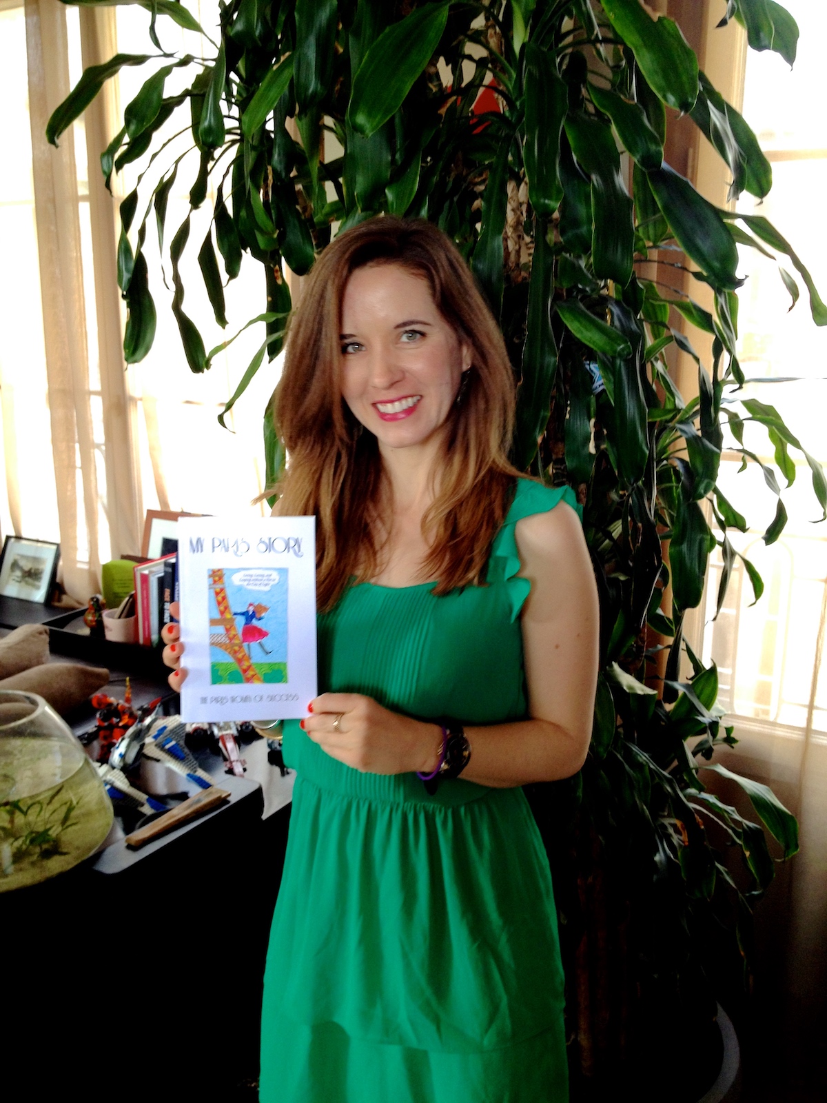 Julia, blogger of Falling Off Bicycles, holding her book, My Paris Story